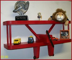 This little shelf is perfect for an airplane enthusiast. Measures 12" Wide. Total height is 9" tall from top of shelf to bottom of wheels. Total depth of shelf is 3.5". Made in the USA with solid wood and accented with movable wheels and propeller. Made in the USA Red Airplane Shelf Solid Wood Construction Colorful and Bright Features Movable Wheels and Propeller.